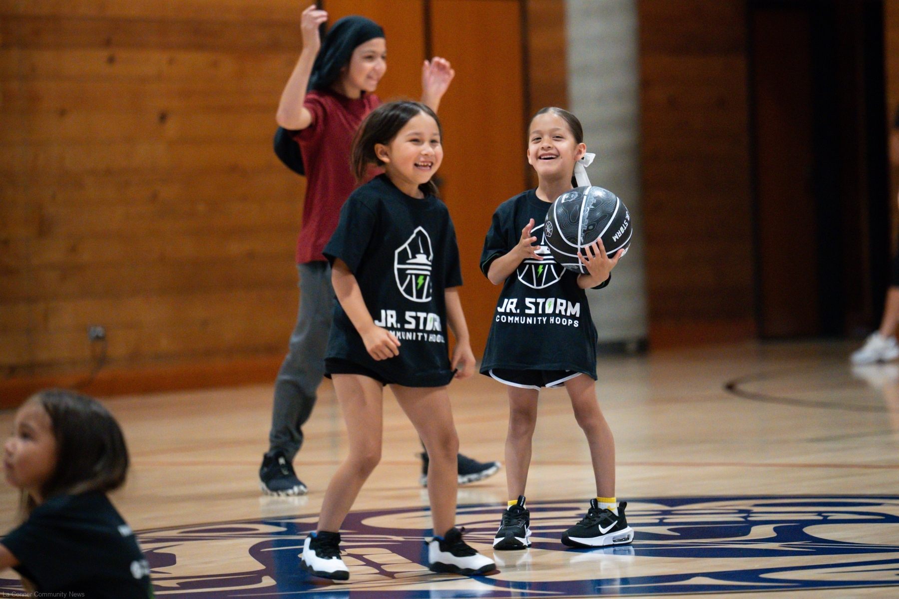 Drea Edwards Gould, left, and Peyton Charles-Bueno have fun during a youth basketball camp at the Swinomish Boys and Girls Club that featured coaching from the Seattle Storm of the WNBA.