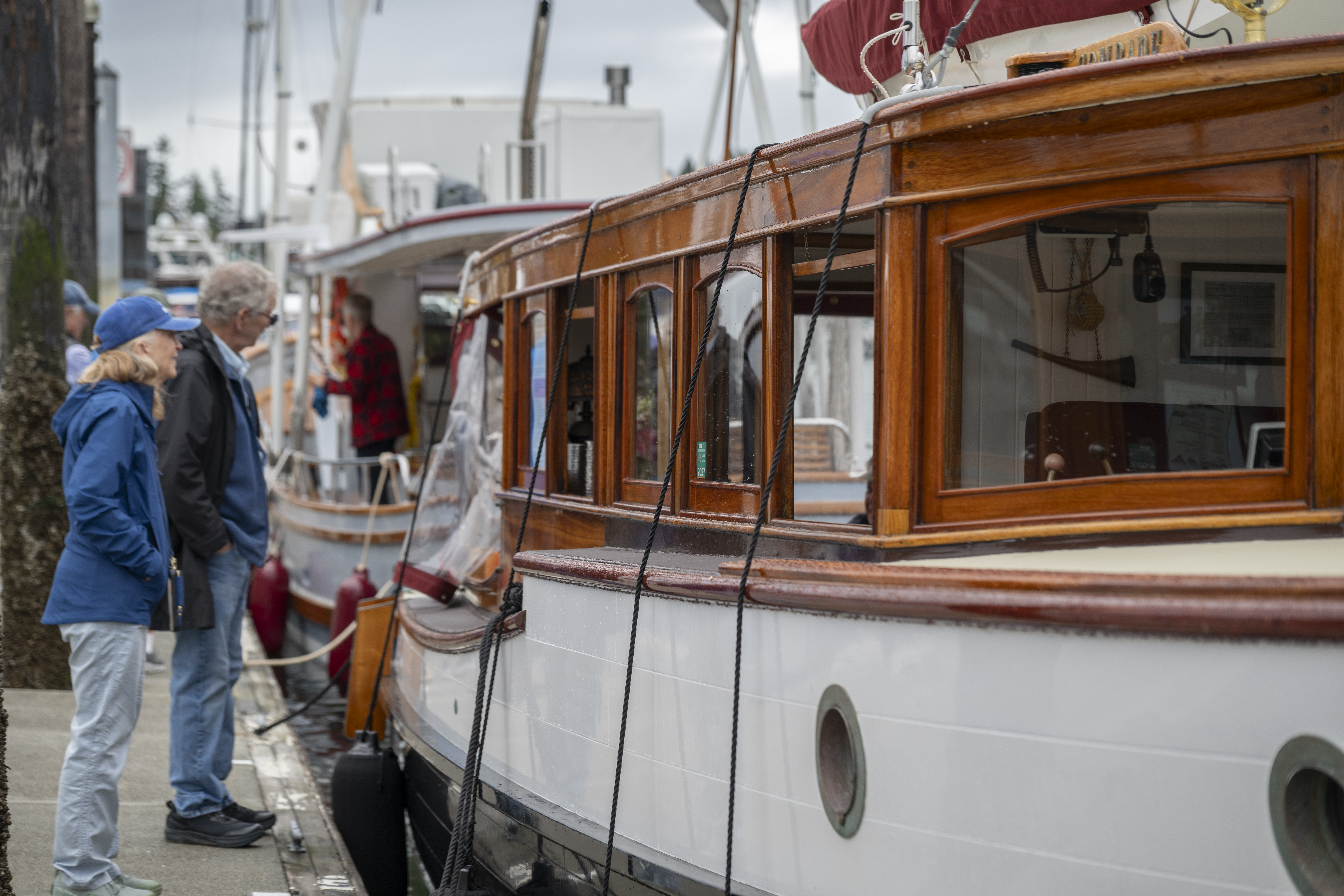 Boat, classic car enthusiasts dodge raindrops at local show